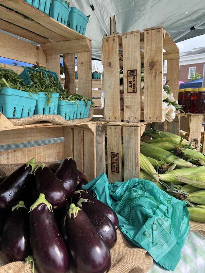 Crates of eggplant and sweet corn